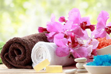 Spa still life with essential oil, salt, orchid and towel