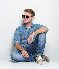 young male looking up and sitting on the floor