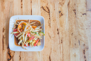 Som Tum (Thai Papaya Salas) on table.