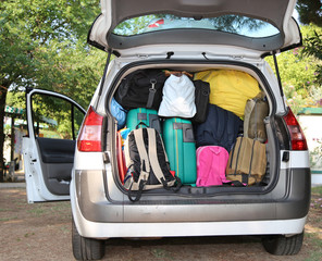 car overloaded with suitcases for travel