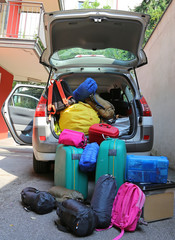luggage and suitcases in car for departure for summer holidays