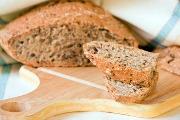 Home-made whole-grain bread with a linen seeds.