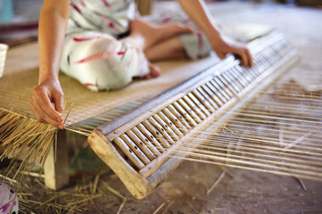 Vietnamese woman weaving a mat