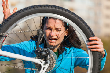 Fototapeta na wymiar Angry woman with damaged bike