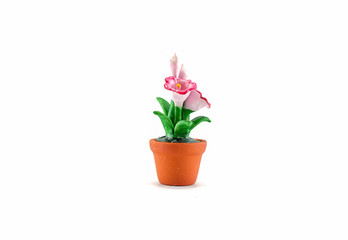 Naklejka na ściany i meble Plastic fake pink flower with brown pot toy isolated on white background