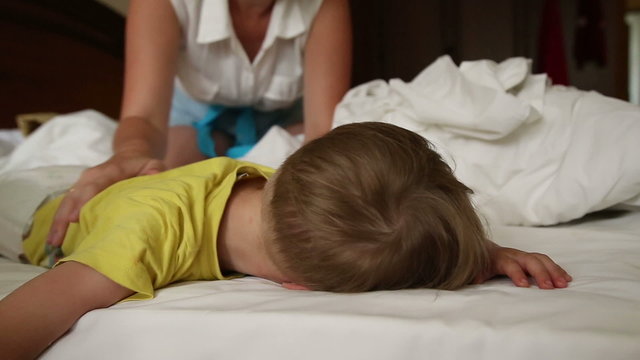 Little boy trying to wake up, and he does not want to wake up
