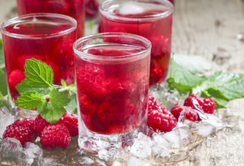 Cold Raspberry drink with mint and ice, selective focus