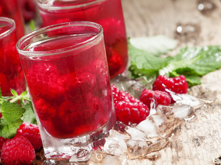 Cold Raspberry drink with mint and ice, selective focus