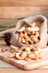 Roasted cashews nuts with natural on wood background