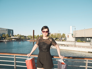 Fototapeta premium beautiful young brunette girl with shopping bags