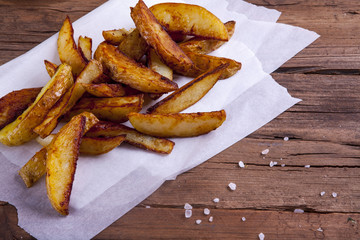 Wedges on cooking paper shot on a wooden background at an angle