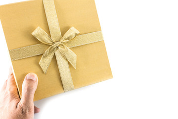 Hand give golden gift box with golden bow