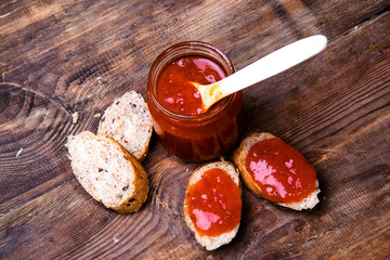 Toast with apricot jam on a wooden background