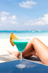 Obraz premium Resort Vacation. Woman relaxing with Blue Curacao Cocktail