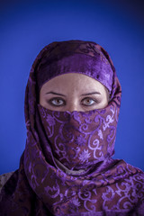 Beautiful arabic woman with traditional veil on her face, intens