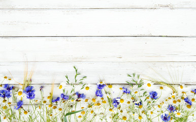 Summer wildflowers and rye on wooden background © Alina G