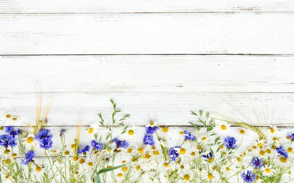 Summer Wildflowers And Rye On Wooden Background