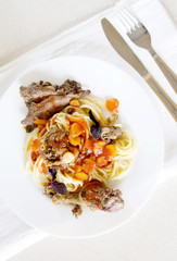 Italian pasta with meat on white plate