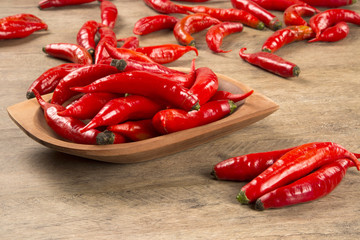 Group of fresh red hot peppers on a wooden table