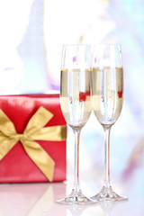 Pair glasses of champagne and present box