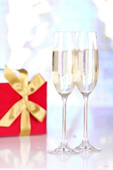 Pair glasses of champagne and present box