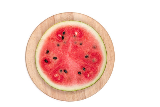 cut watermelon on wooden board isolated