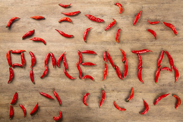 Group of fresh red hot peppers on a wooden table