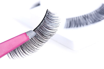 False lashes and pink pincers, closeup