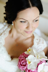 beautiful bride with a wedding bouquet of orchids