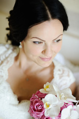 beautiful bride with a wedding bouquet of orchids