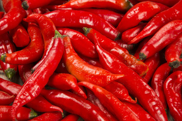 Group of fresh red hot peppers on a wooden table