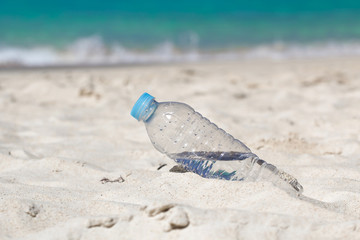 Fototapeta na wymiar Water in bottle on beach