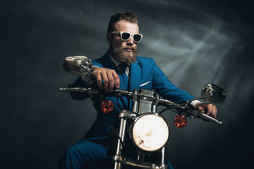 Fototapeta na wymiar Stylish trendy man on a motorcycle