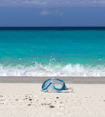 Fototapeta na wymiar Swimming mask on white sand on tropical beach