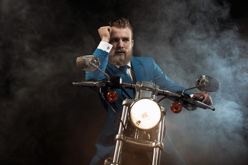 Fototapeta na wymiar Handsome businessman on a motorbike