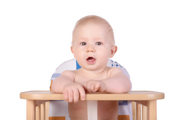 Adorable baby in high chair isolated