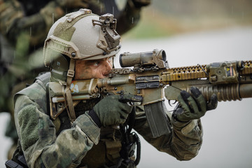 Fototapeta premium Portrait of a ranger in the battlefield with a gun