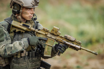 Portrait of a ranger in the battlefield with a gun