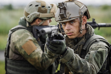 Portrait of a ranger in the battlefield with a gun