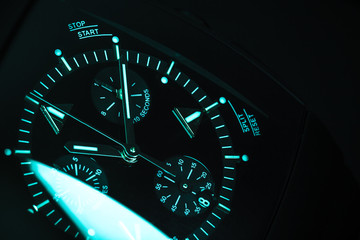 Clock deal with blue green illumination. Close-up