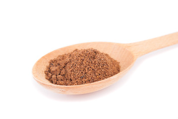 Shredded clove in spoon isolated on white background.