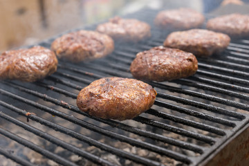 Close Up of Juicy Burgers Cooking on Smoking Grill