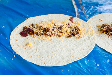 Simple Tacos Topped with Cheese on Flour Tortillas