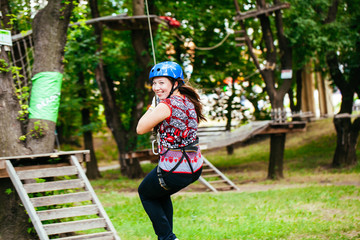 Adventure climbing high wire park - woman on course in mountain