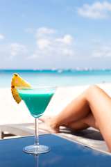 Resort Vacation. Woman relaxing with Blue Curacao Cocktail