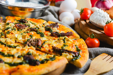 Delicious homemade pizza with cheese meat and mushrooms on a