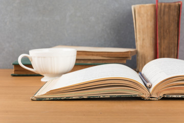 old book with pencil and coffee