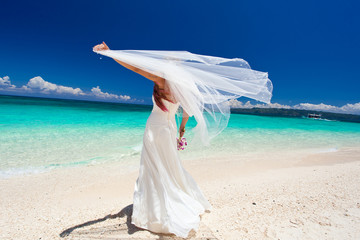 Fototapeta na wymiar Happy dancing bride on beach
