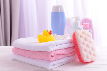 Obraz na płótnie Canvas Baby accessories for bathing on table on light background