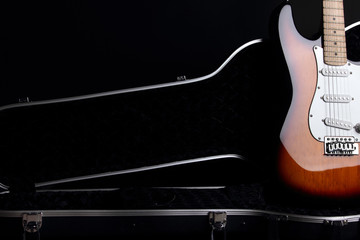 Electric guitar in guitar case, on black background